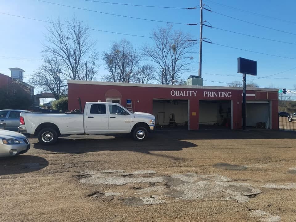 Nichols and Sons Construction dually truck parked at a commercial job site