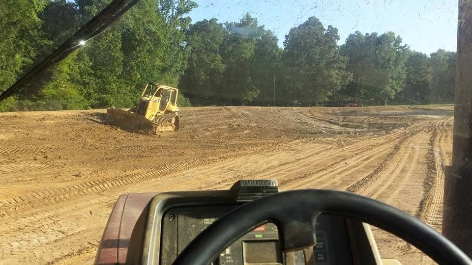 View from inside the equipment cab of a bulldozer clearing a building site