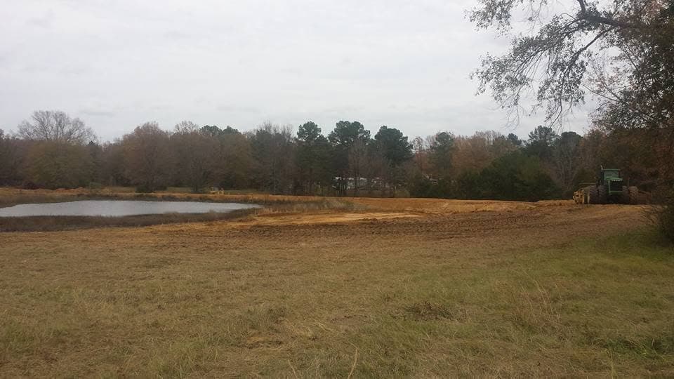 Completed pond surrounded by cleared land